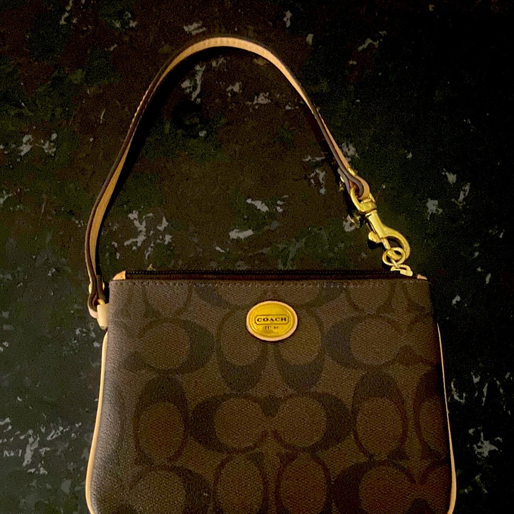 Coach wristlet, brown signature coach with tan piping. Preowned